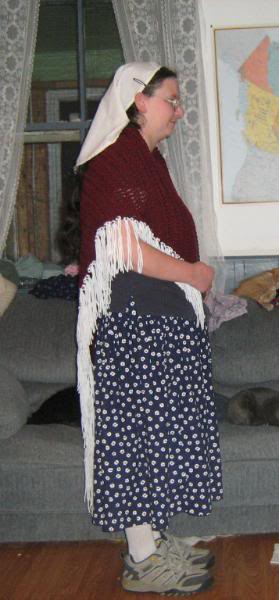 Me wearing a maroon triangle shawl with a white fringe.