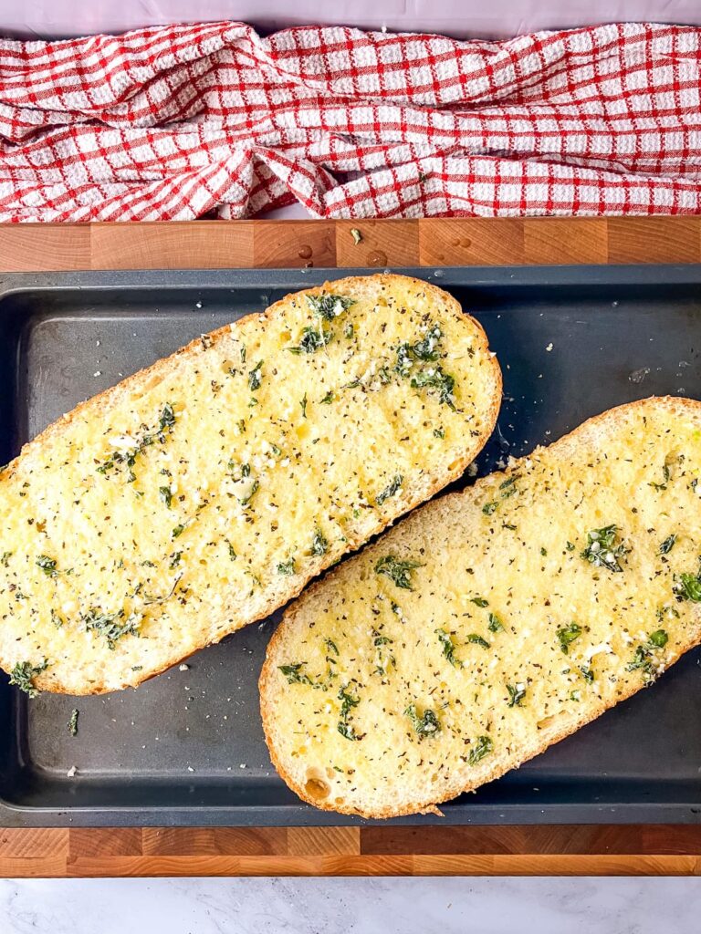 Homemade garlic bread on a baking tray.