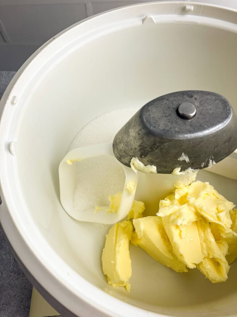 Butter and sugar in a stand mixer bowl.