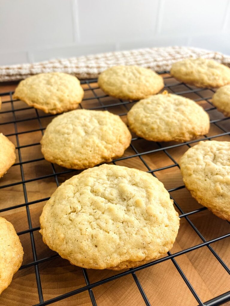 Homemade oatmeal cookies cooling on a wire rack.