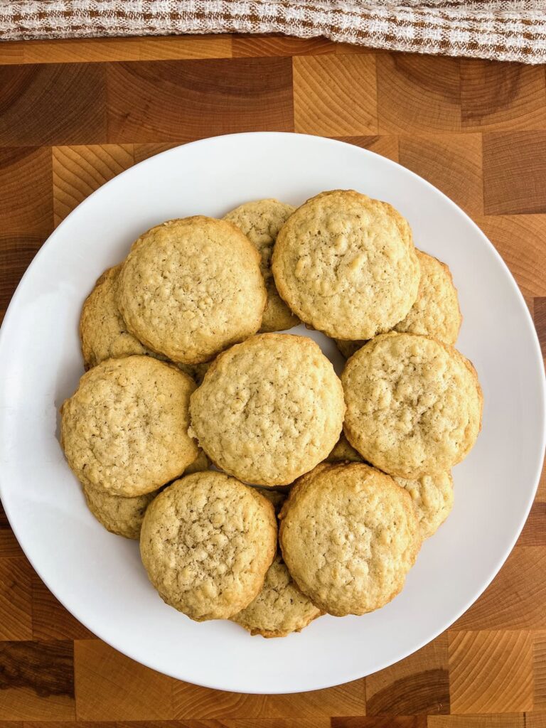 Homemade oatmeal cookies on a white plate.