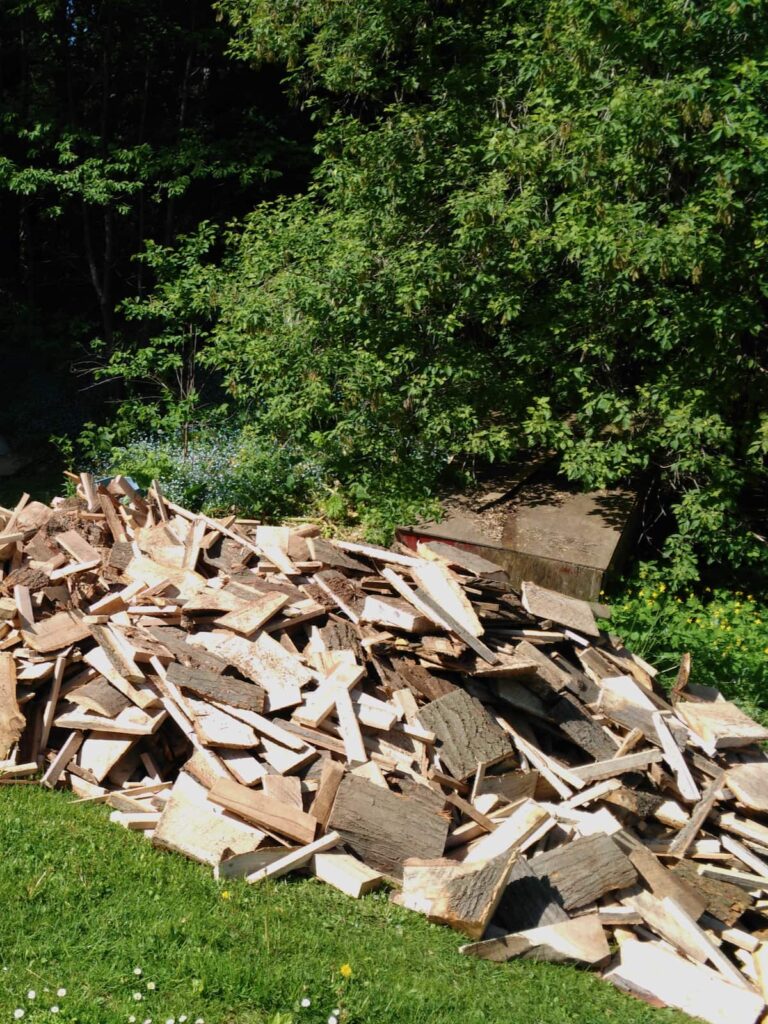 A large pile of mill ends for firewood.