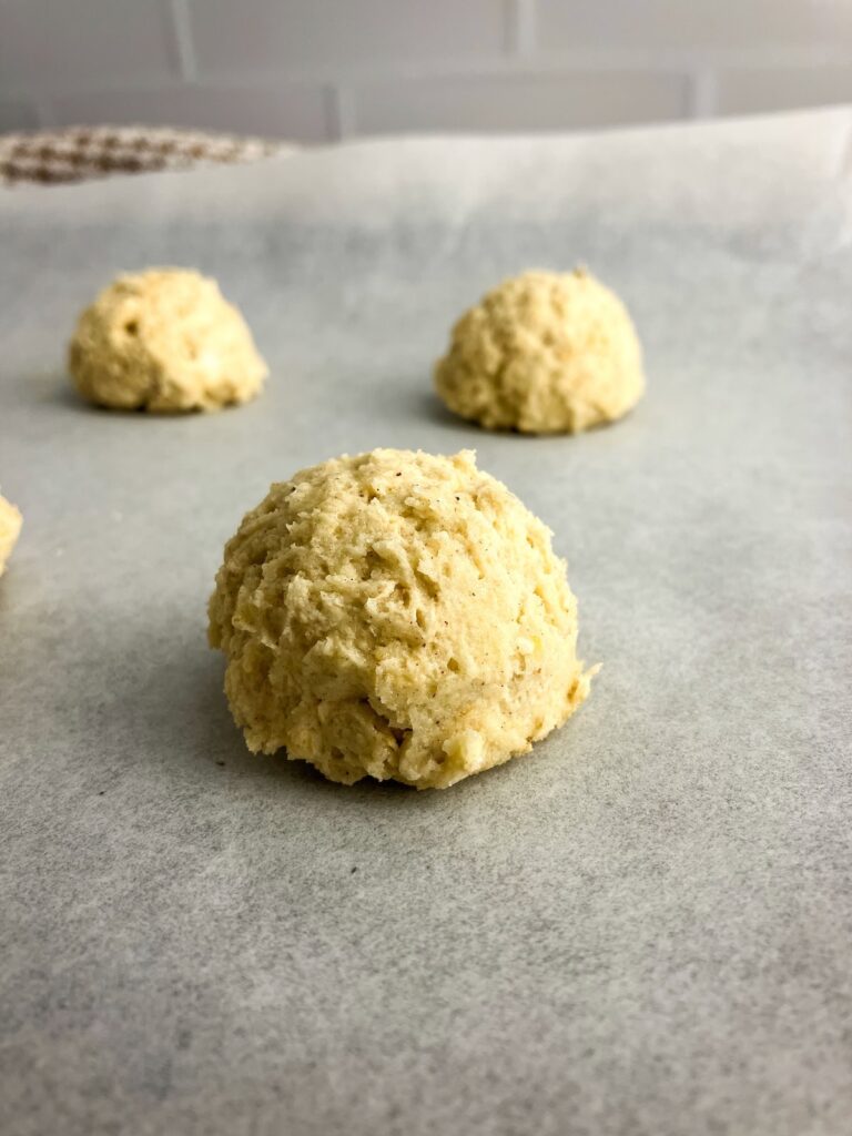 Oatmeal cookie dough balls on a baking sheet.