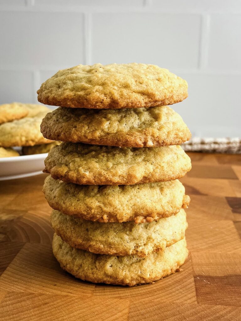 Stack of homemade soft and chewy oatmeal cookies on a wooden counter.
