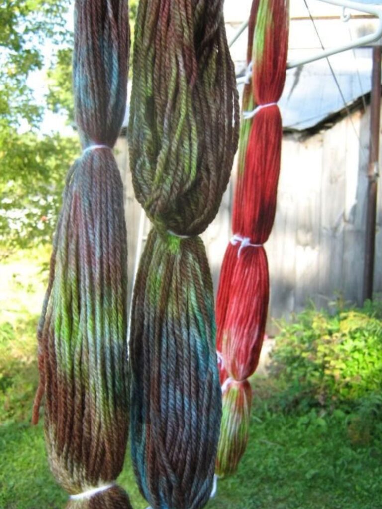 Yarn dyed with Kool-Aid hanging on a clothesline to dry.