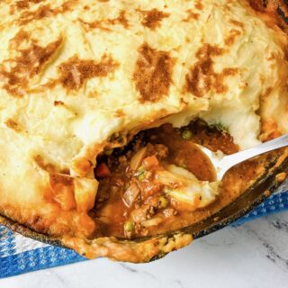 Skillet Shepherd's pie with a spoonful removed to see inside.