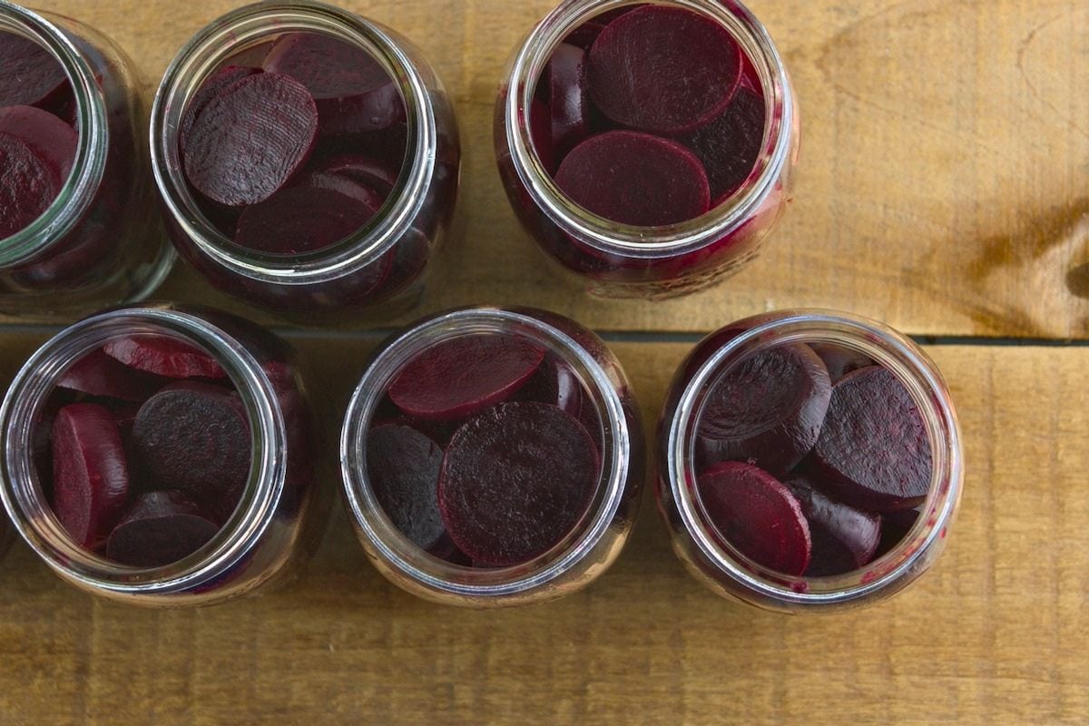 Mason jars filled with sliced red beets.