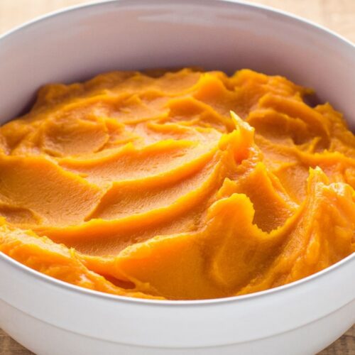 White serving bowl of homemade butternut squash puree.