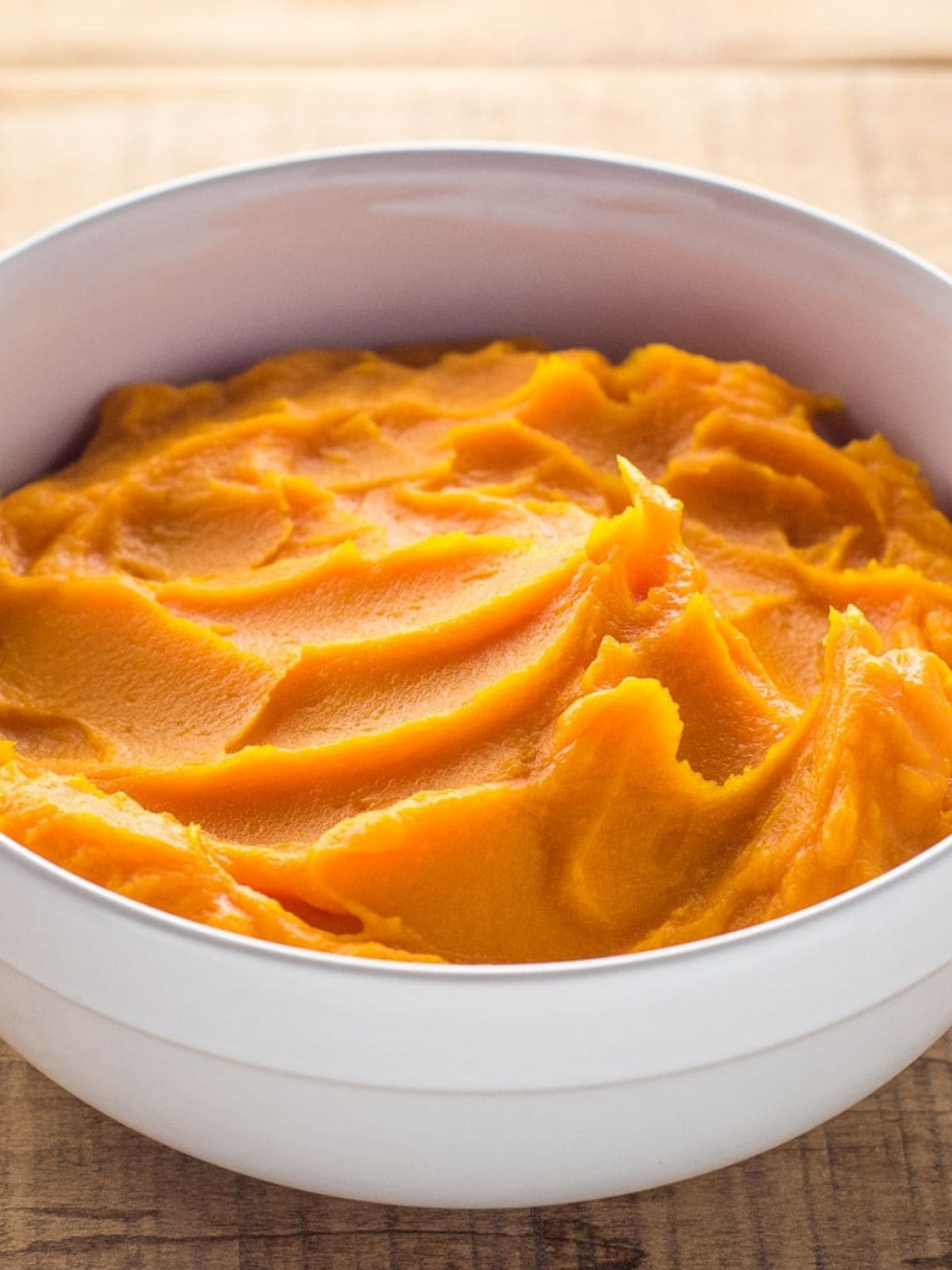 White serving bowl of homemade butternut squash puree.