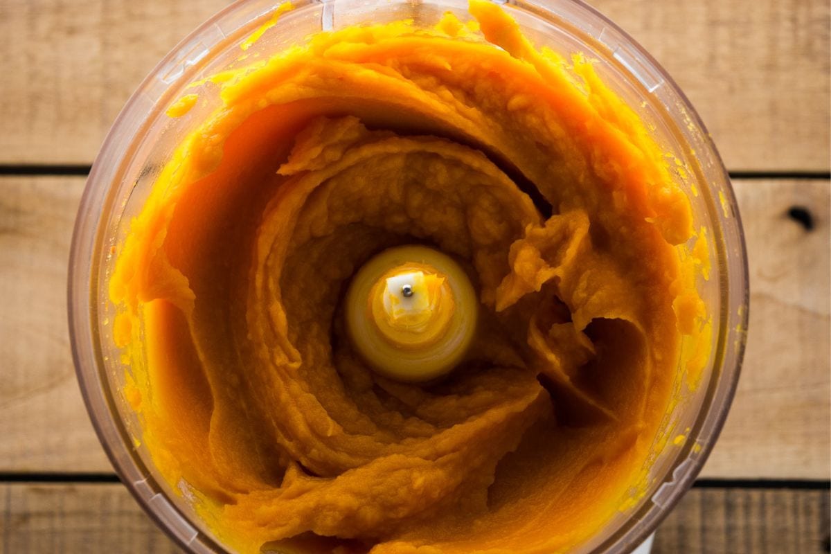 Pureed butternut squash in a food processor bowl.
