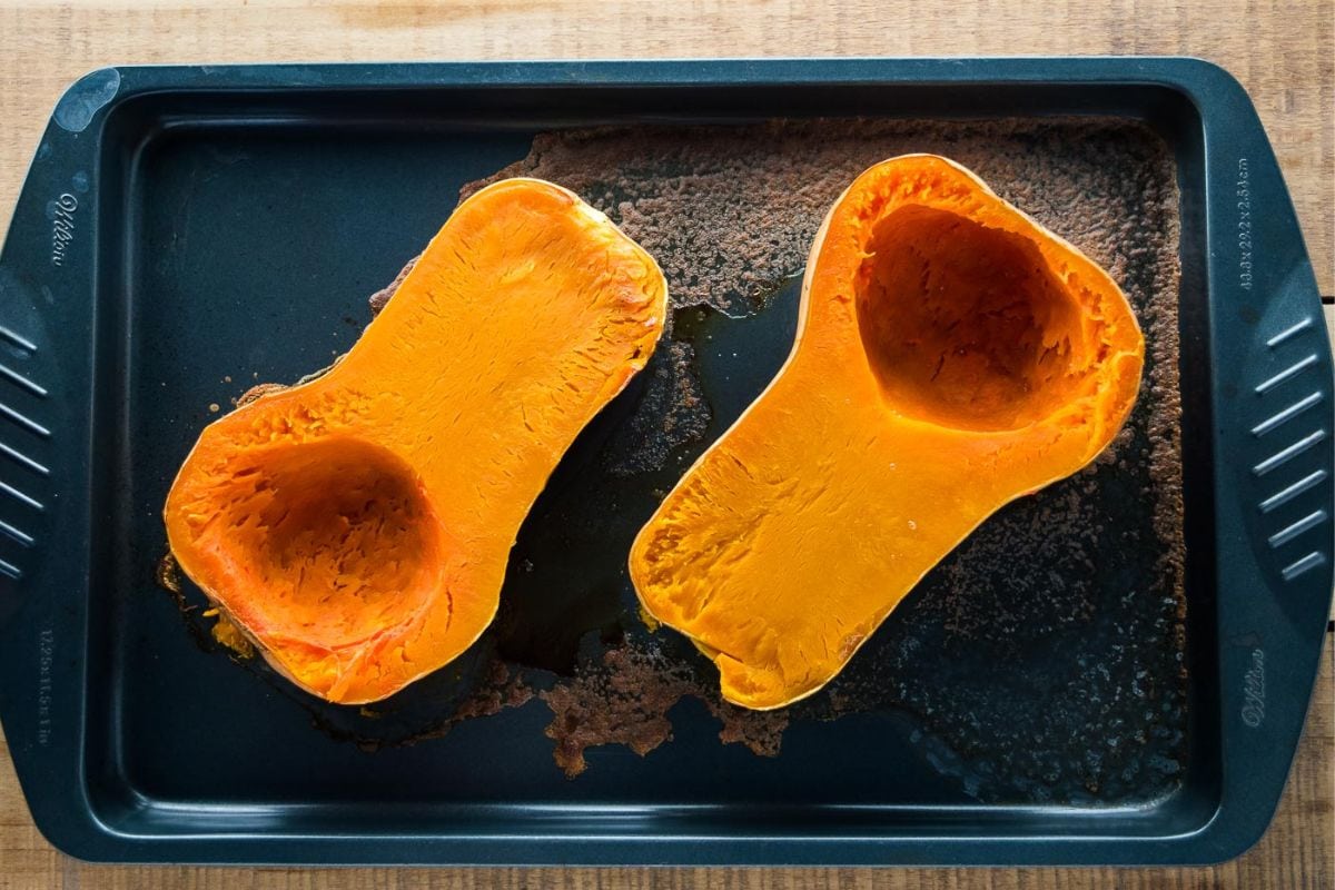Cooked butternut squash on a baking tray.