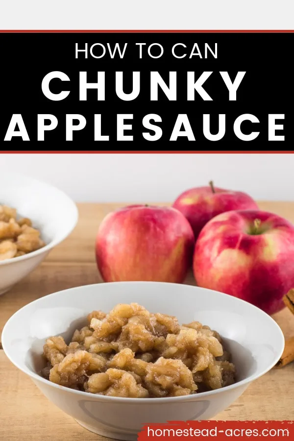 White bowl of chunky applesauce on a wooden table with another bowl of applesauce in the background along with 3 red apples. Overlay text reads How To Can Chunky Applesauce.