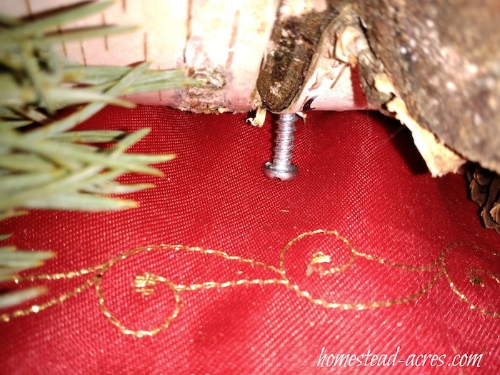 Close up of the screws used as legs on the log candle holder.