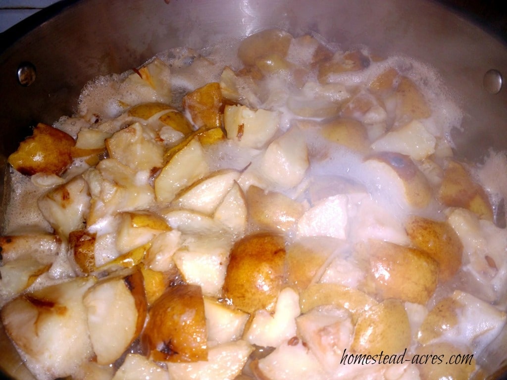 Pears are boiling in a large stock pot.