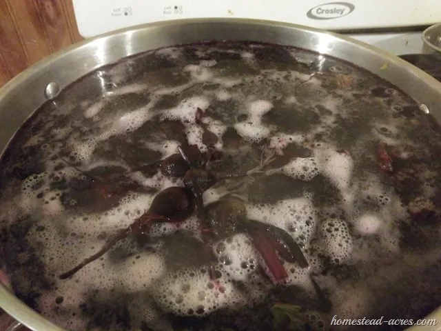 Large pot filled with beets and water starting to come to a boil.