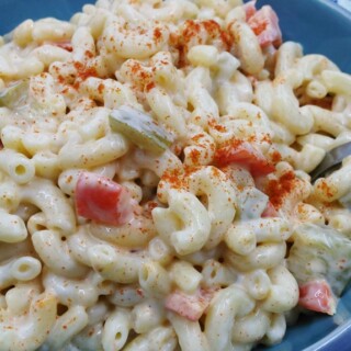 Homemade creamy pasta salad in a blue bowl.