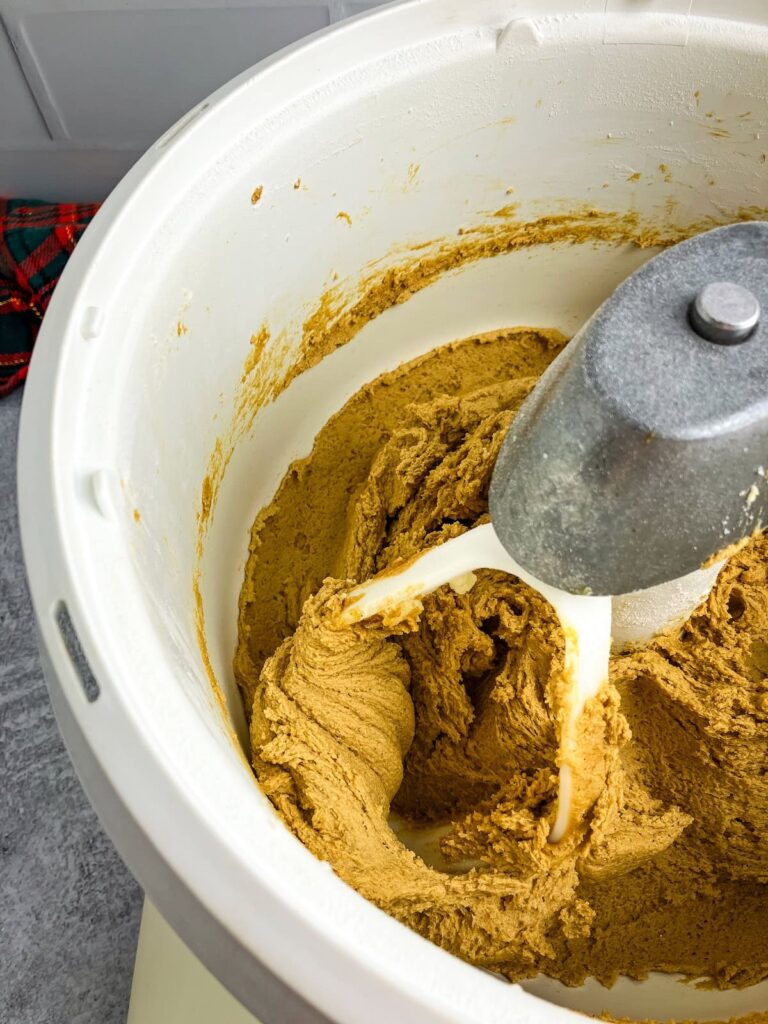 Ginger molasses cookie batter in a stand mixer.