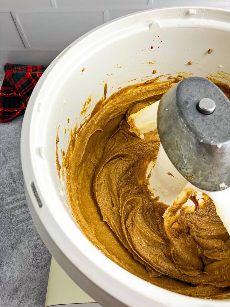 Wet cookie ingredients mixed in a stand mixer.
