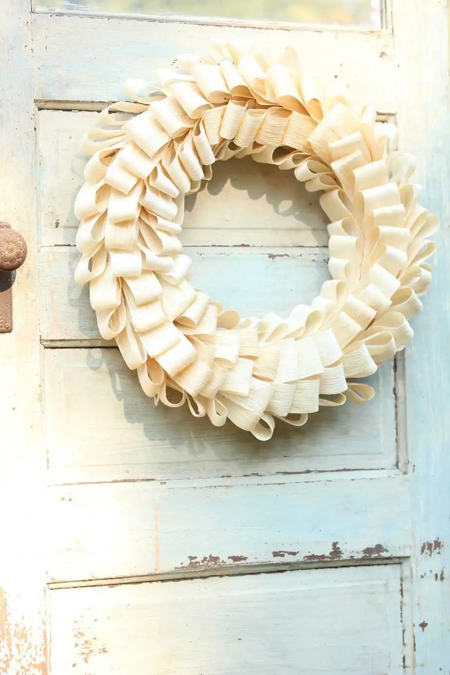 Corn husk wreath hanging on a door.