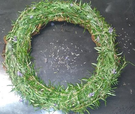 A green herb wreath laying on a table.