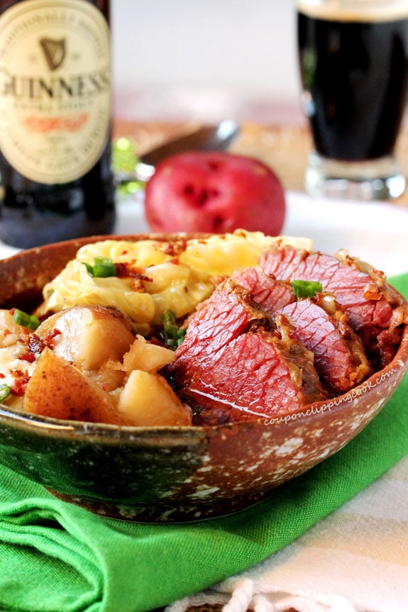 Guinness corned beef and potatoes in a brown bowl.