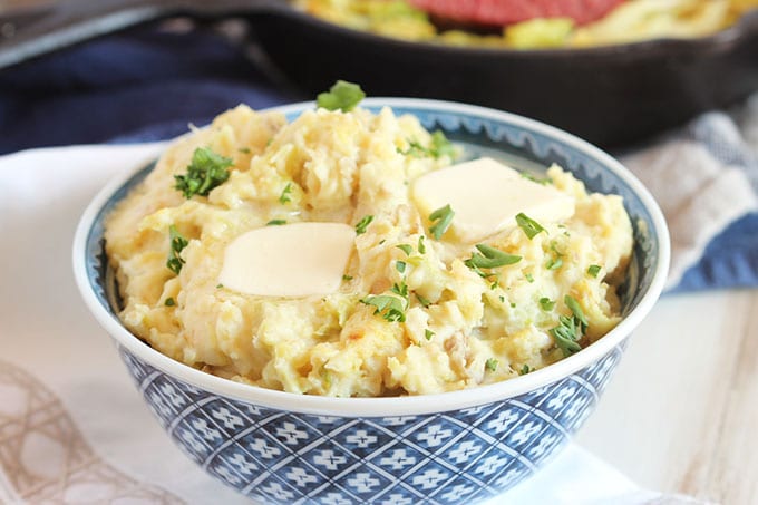 A bowl of colcannon topped with butter.