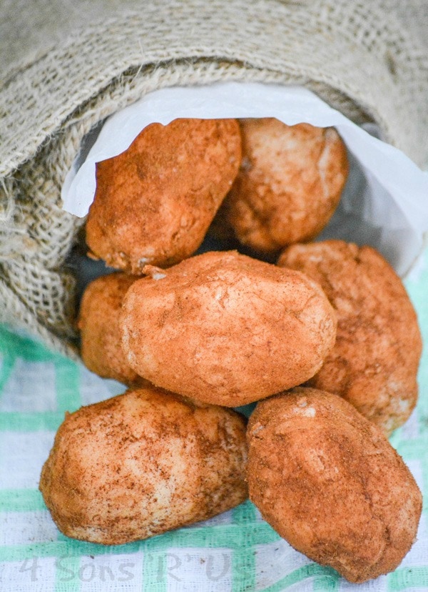 Irish potato candy spilling out of a burlap serving bag.