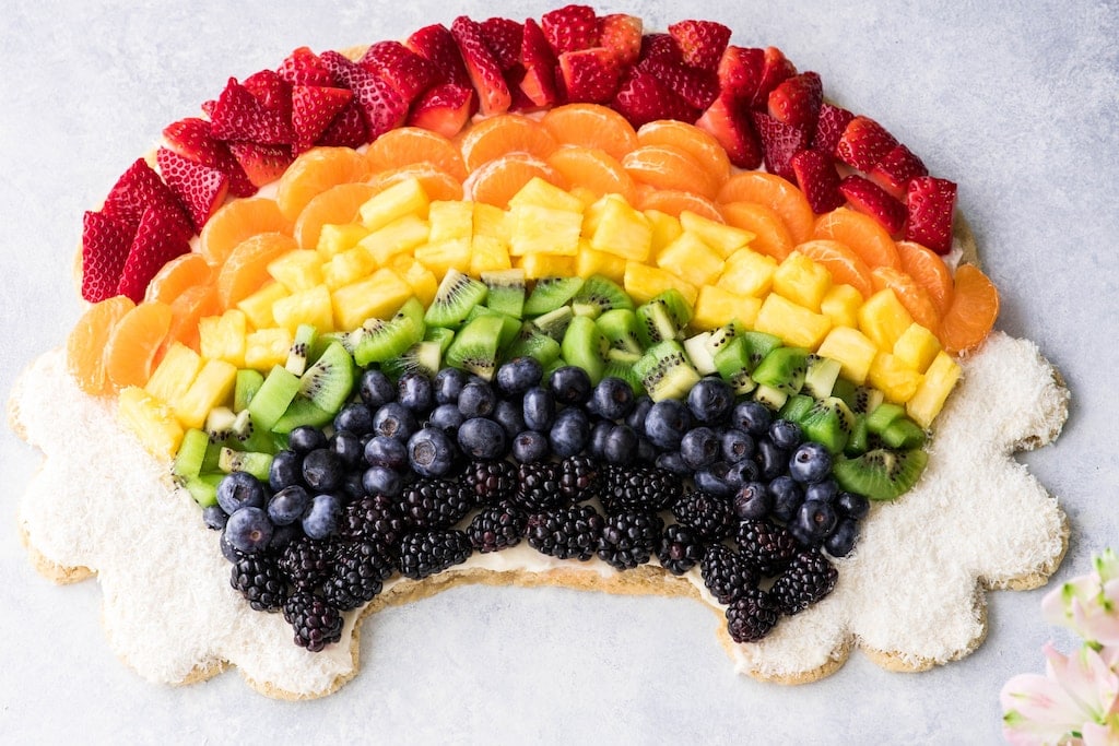 Rainbow fruit pizza with a sugar cookie crust.