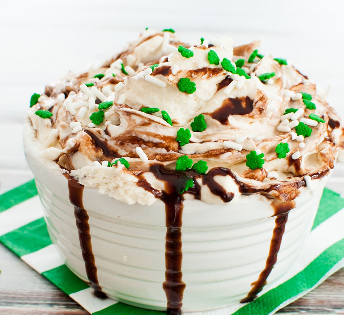 A large serving bowl of Baileys Irish cream dip topped with chocolate.