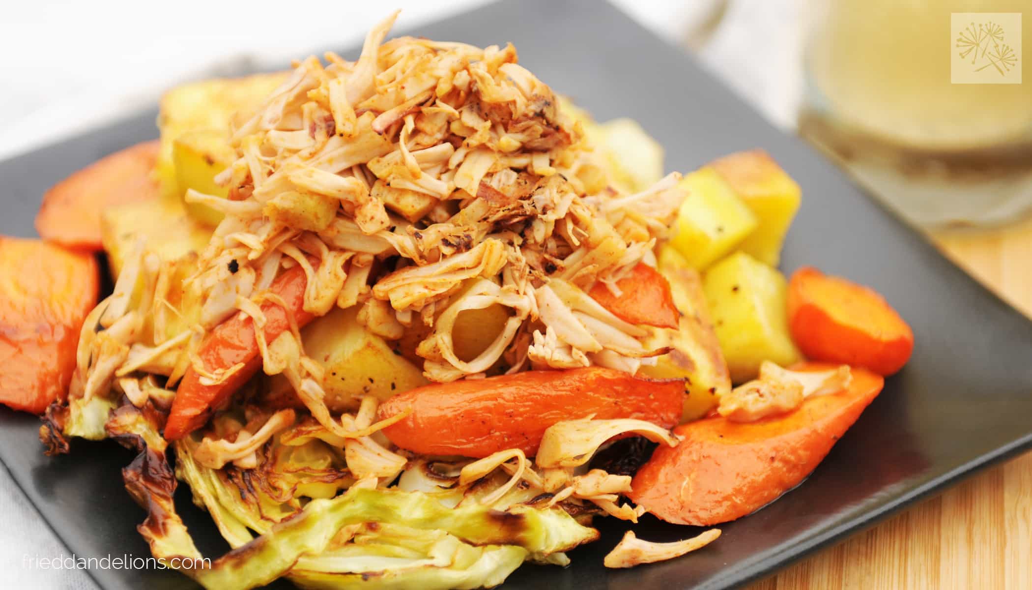 Corned jackfruit, potatoes, and carrots on a grey plate.