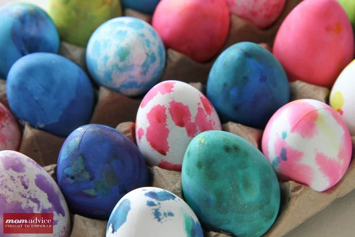 Plastic Easter eggs dyed and sitting in a holder.