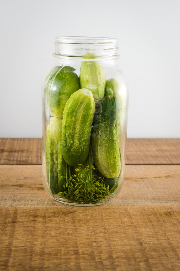 Packing cucumbers into jars.