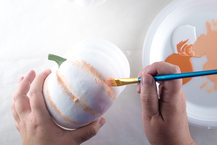 Dry brushing on orange paint into the grooves.