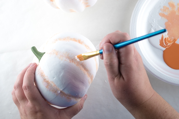 Dry brushing white paint over the orange.
