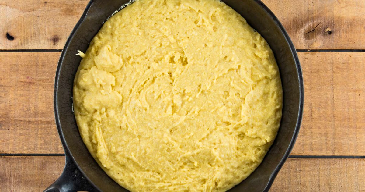 Cornbread batter poured into a hot skillet.