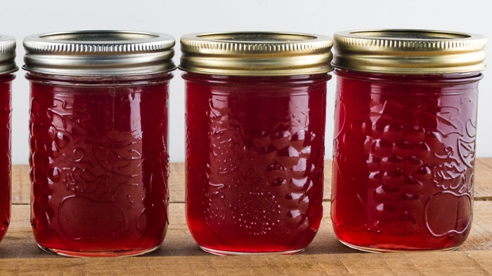 Jars of homemade jelly that have set firm.