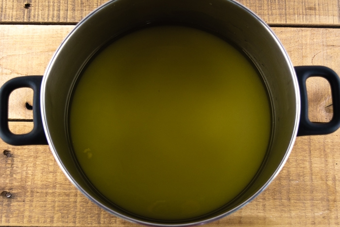 Dandelion flower liquid and sugar in a large pot.