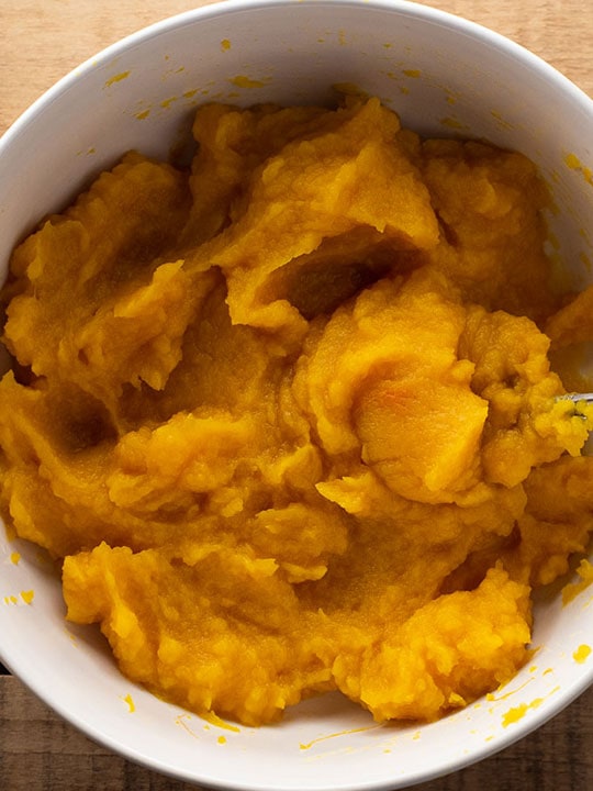 White bowl of homemade pumpkin puree.