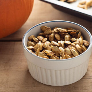 Homemade roasted pumpkin seeds in a bowl.