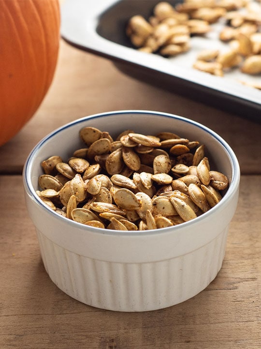 Serving bowl of homemade roasted pumpkin seeds.