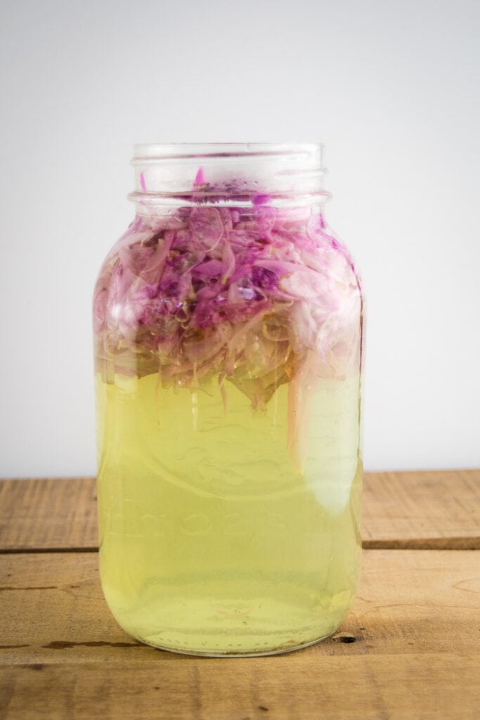 Steeping peony flowers in a jar.