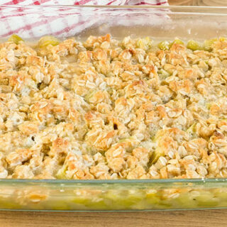 9x13 inch pan of rhubarb crisp cooling on the table.