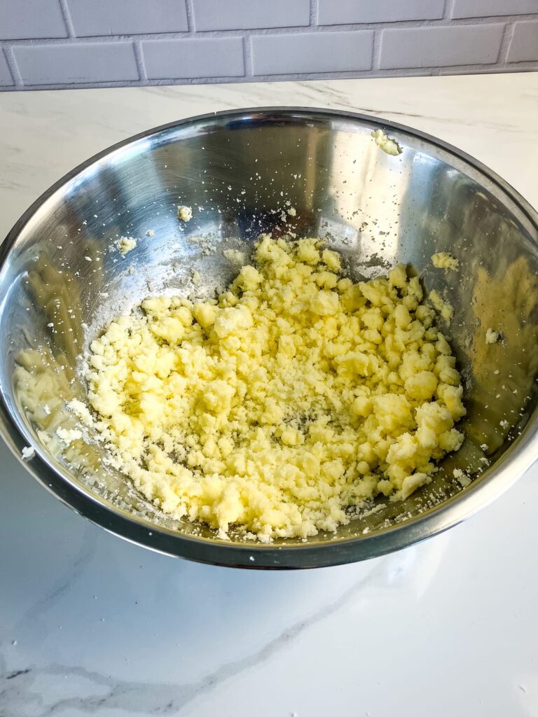 Mixing bowl with creamed butter, sugar, and eggs.