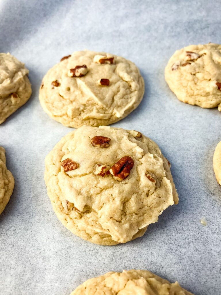 Butter pecan cookies cooling on a cookie sheet.