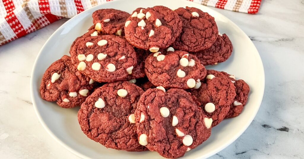 A white plate filled with red velvet cookies made from a cake mix.