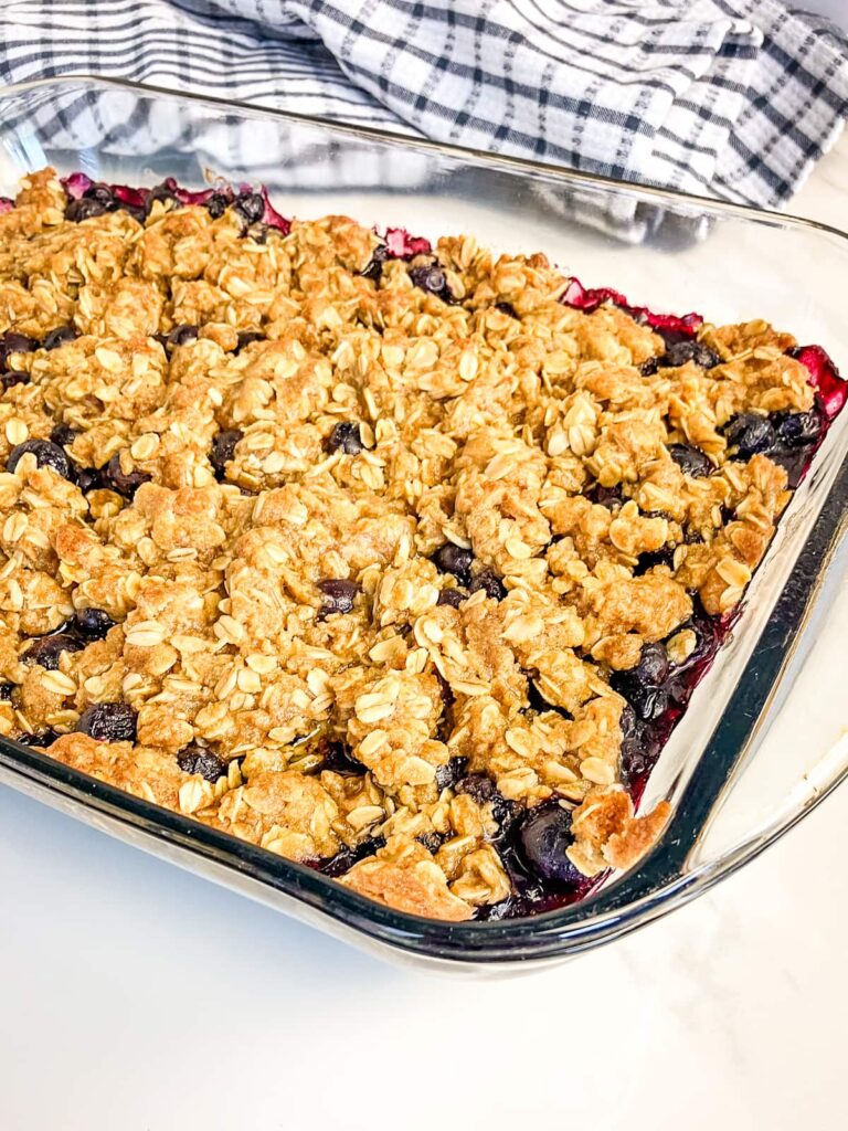 Homemade blueberry crisp in a glass baking pan.