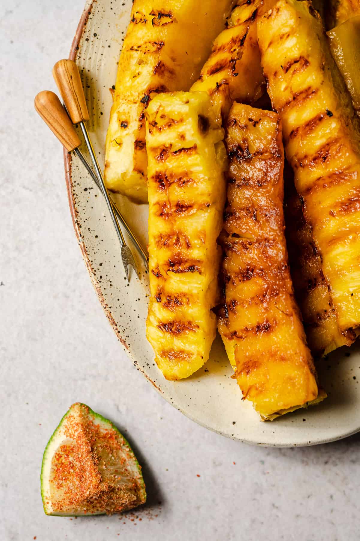 Serving platter of spicy grilled pineapple with limes.