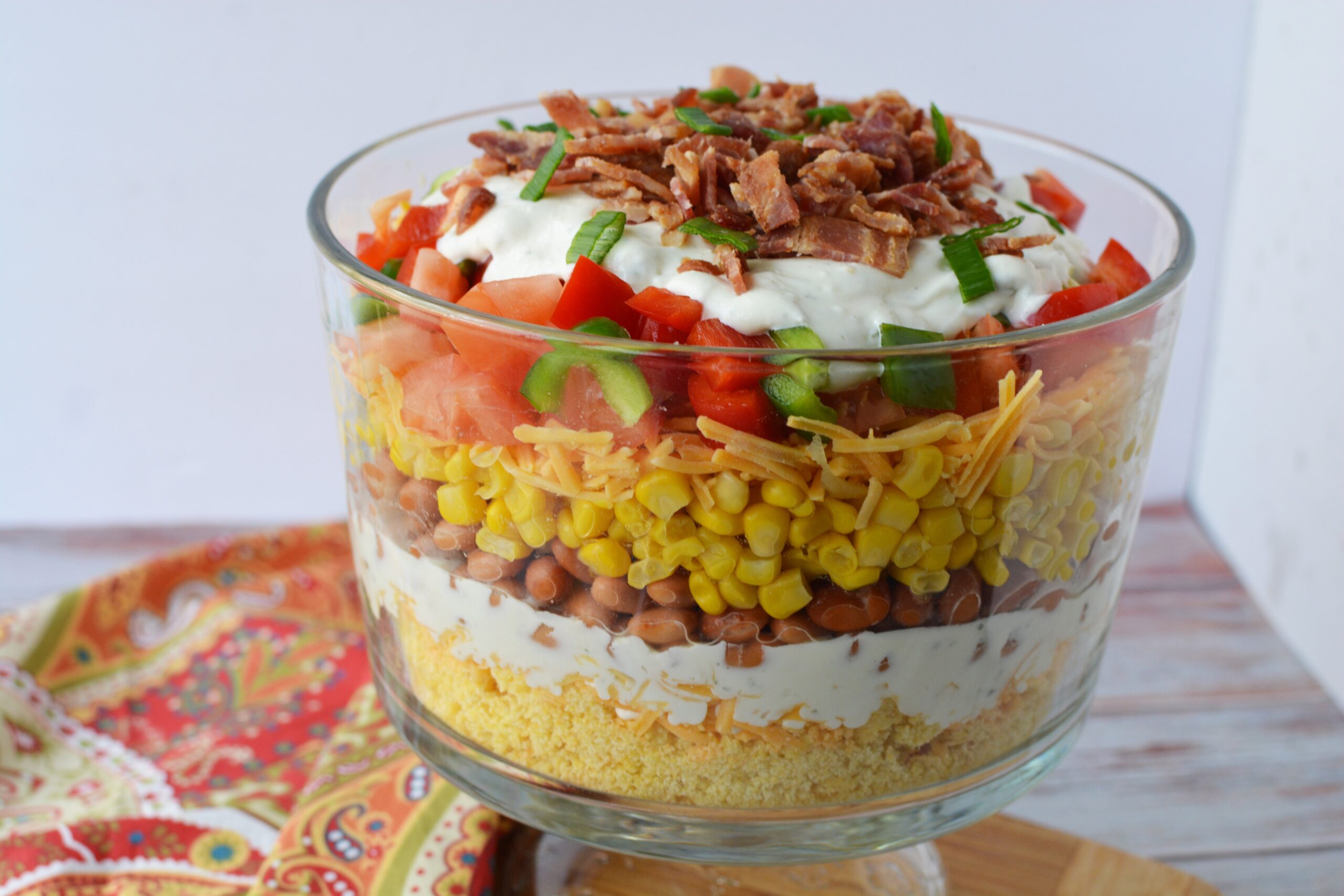 Layered cornbread salad in a large serving dish.