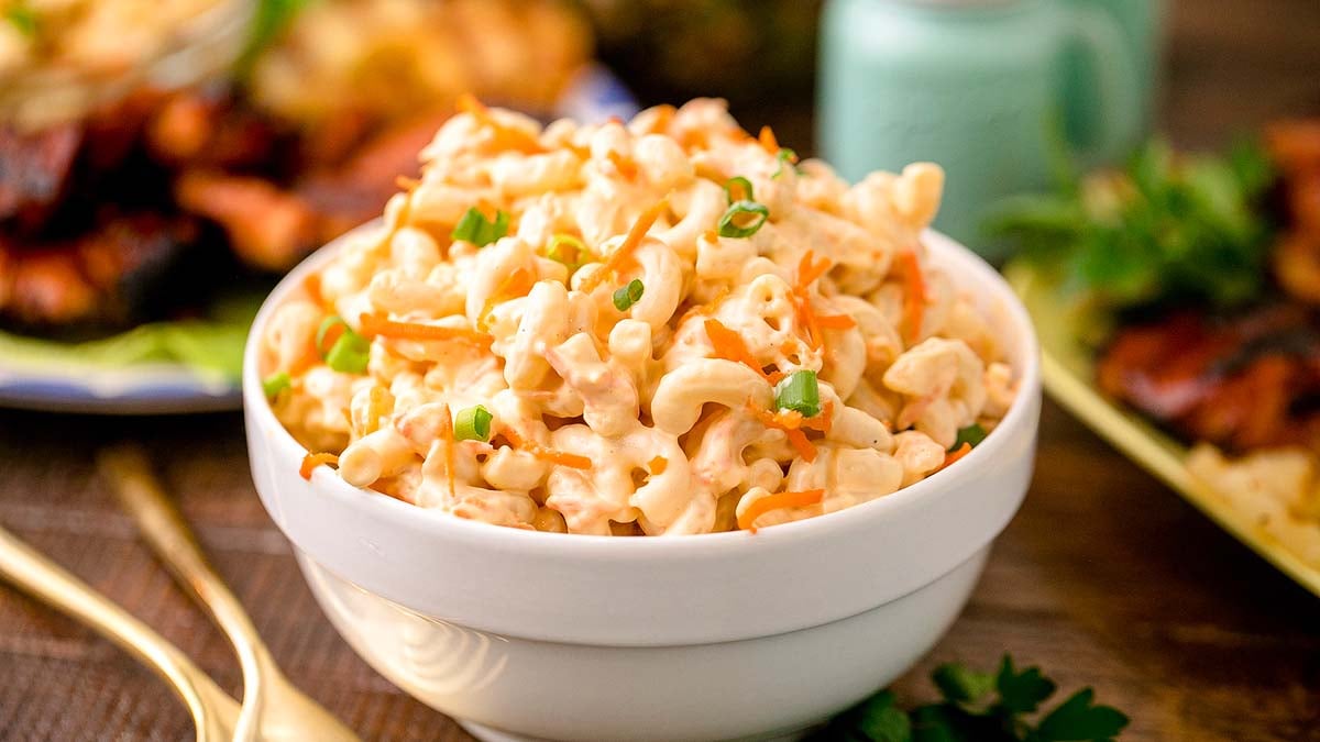 A white bowl heaped with Hawaiian macaroni salad.