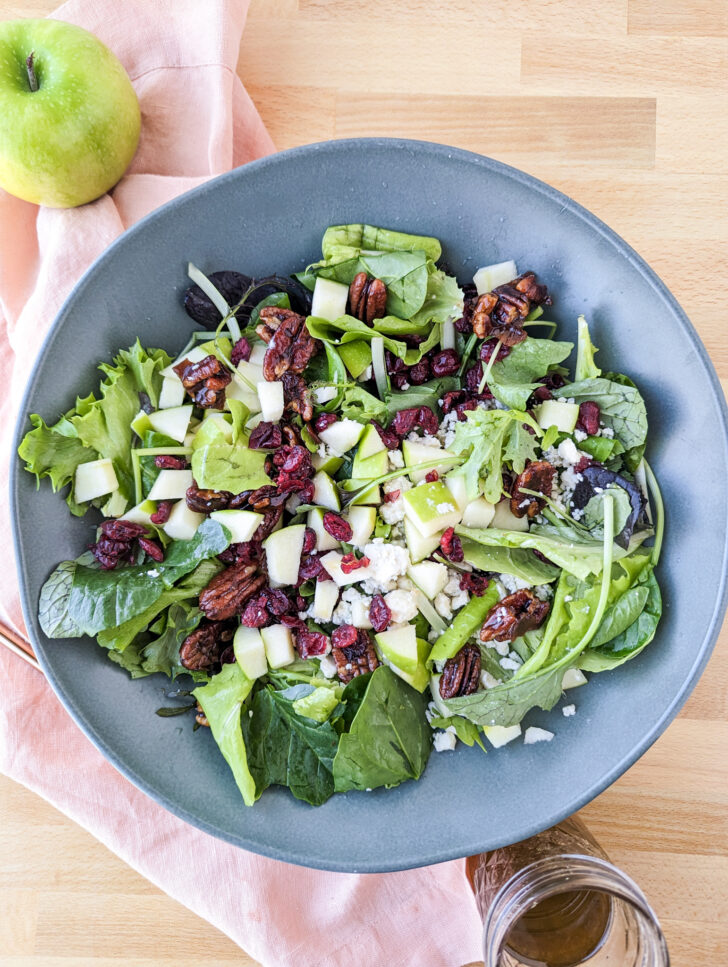 Apple gorgonzola salad in a blue bowl.